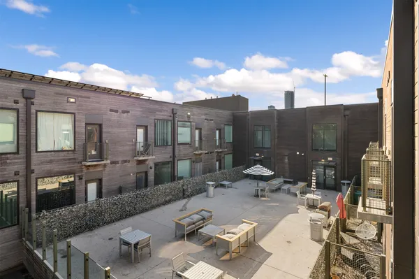 a view of a patio with couches table and chairs and potted plants