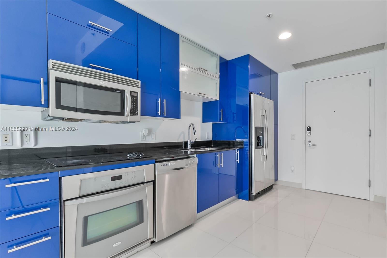 60 Southwest 13th Street, Unit 2618 Miami, FL 33130 - Photo 12 of 24 a kitchen with stainless steel appliances granite countertop a stove microwave and refrigerator
