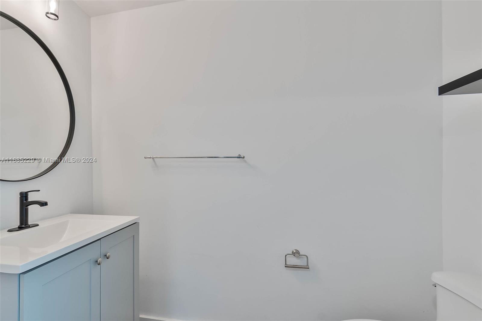 60 Southwest 13th Street, Unit 2618 Miami, FL 33130 - Photo 14 of 24 a bathroom with a sink and mirror