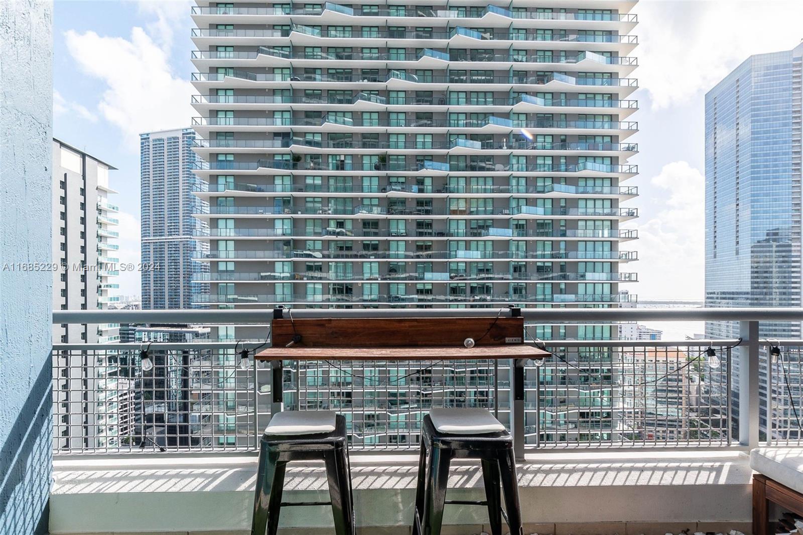 60 Southwest 13th Street, Unit 2618 Miami, FL 33130 - Photo 16 of 24 a view of a balcony with a bench and a window