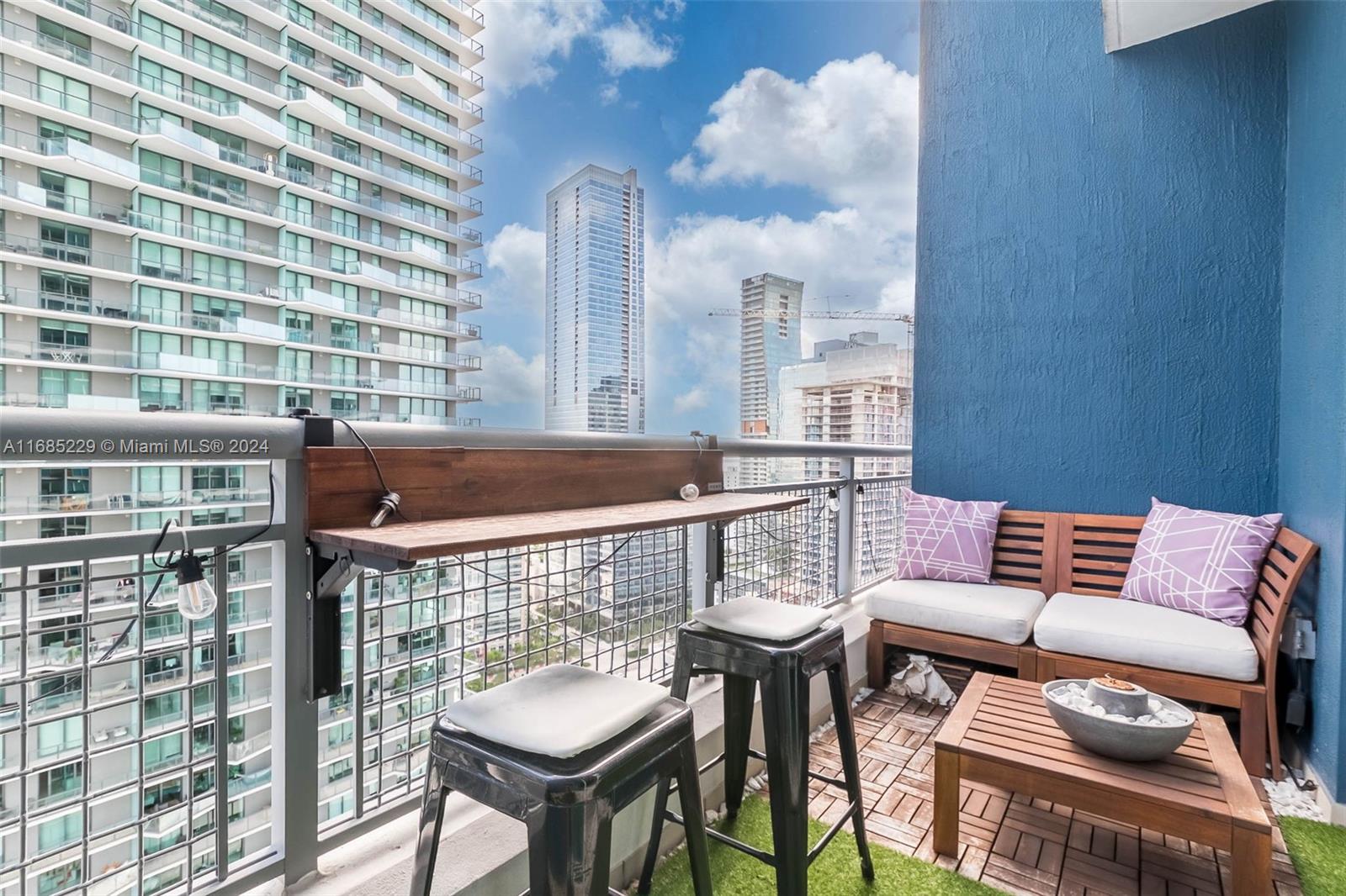 60 Southwest 13th Street, Unit 2618 Miami, FL 33130 - Photo 17 of 24 a roof deck with a table and chairs