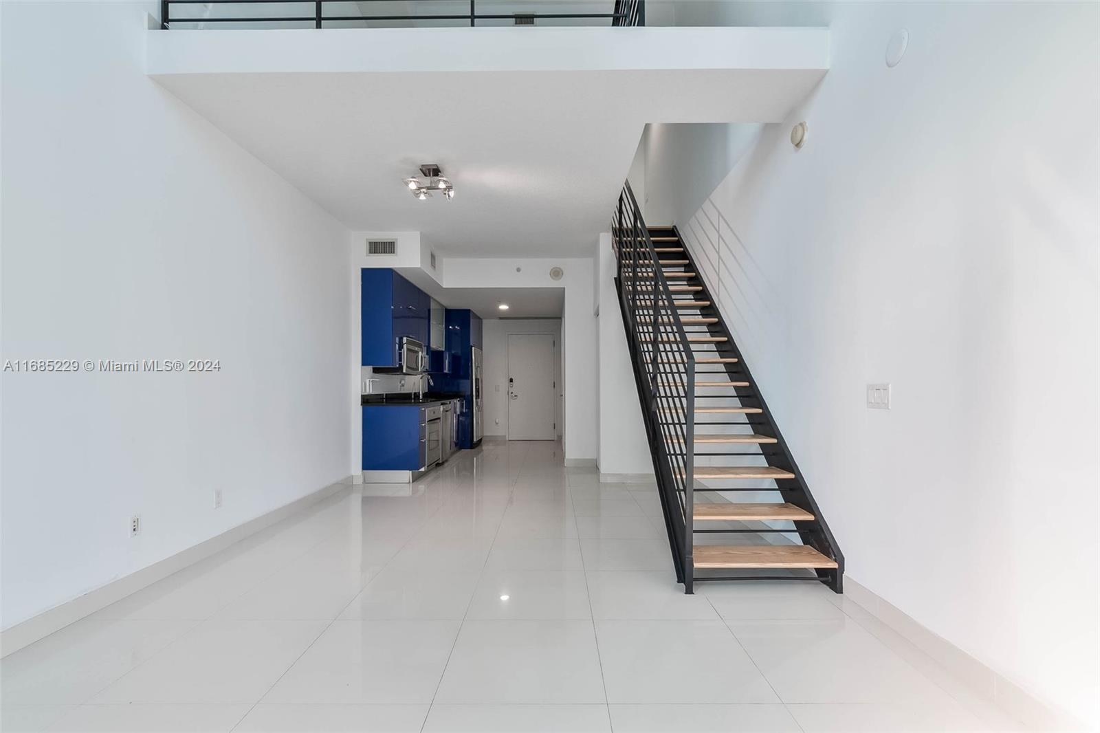 60 Southwest 13th Street, Unit 2618 Miami, FL 33130 - Photo 3 of 24 a view of an empty room with stairs