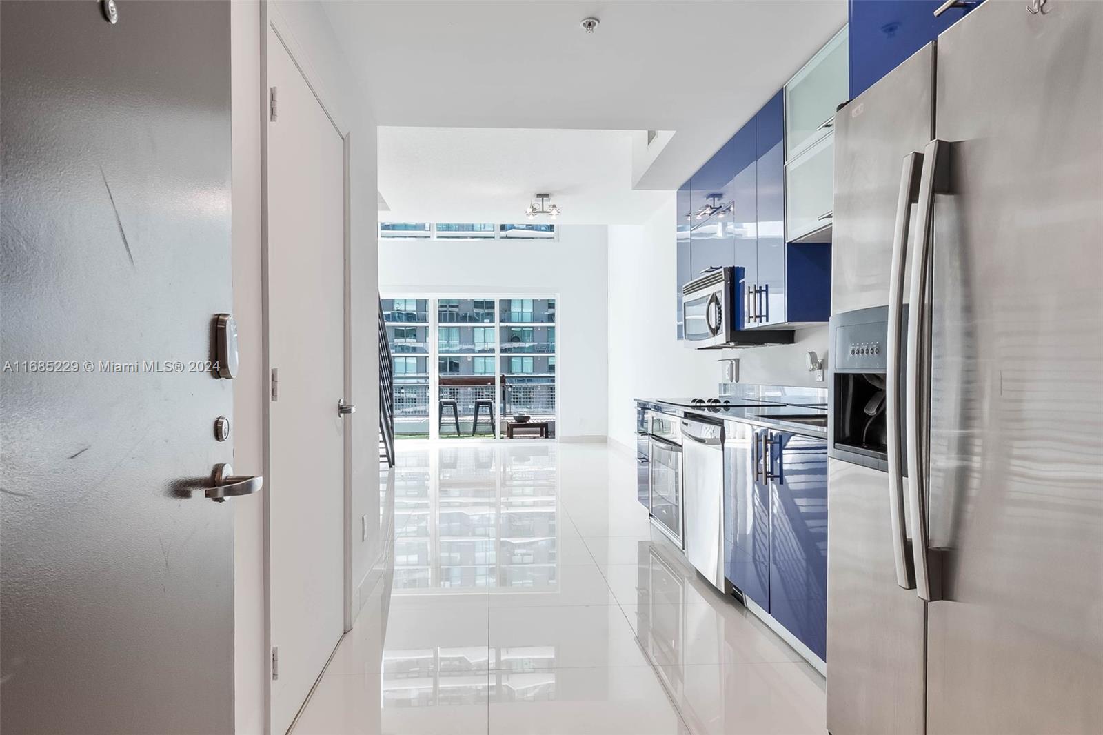 60 Southwest 13th Street, Unit 2618 Miami, FL 33130 - Photo 10 of 24 a kitchen with stainless steel appliances a refrigerator and a stove top oven