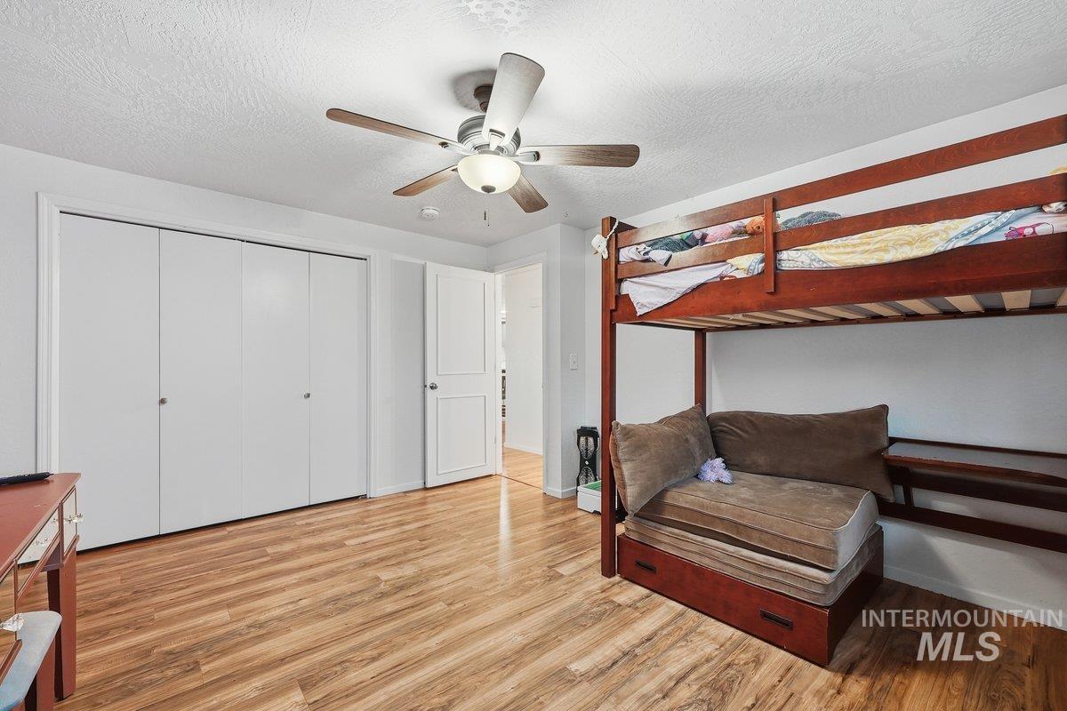 2920 South 10th Avenue Caldwell, ID 83605 - Photo 13 of 21 Bedroom with wood finished floors, a textured ceiling, ceiling fan, and a closet