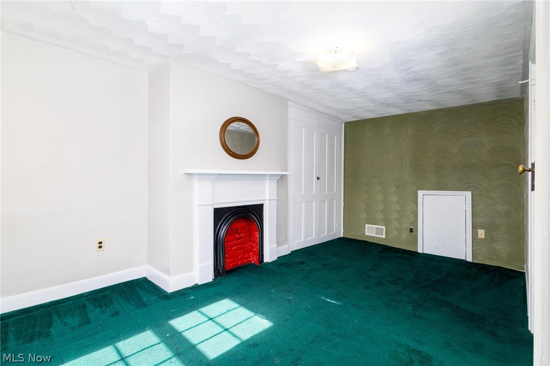 165 9th Street Wellsburg, WV 26070 - Photo 30 of 37 Unfurnished living room with carpet floors and a fireplace