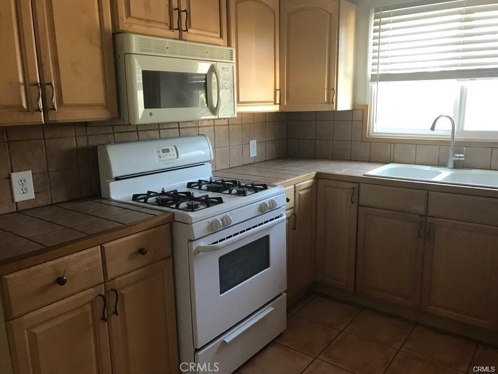 110 Ruby Drive Placentia, CA 92870 - Photo 9 of 9 a kitchen with granite countertop a stove sink and cabinets