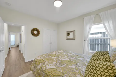 a bedroom with a bed and a lamp on dresser
