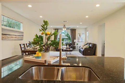a view of kitchen with a sink and living room