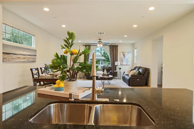 a view of kitchen with a sink and living room