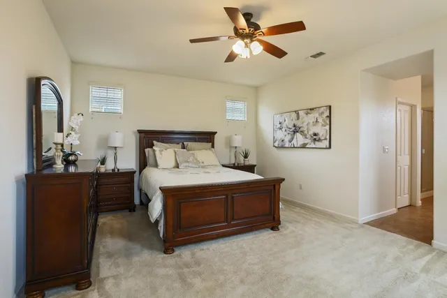 a bedroom with a large bed and a chandelier