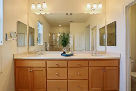 a bathroom with a double vanity sink and a mirror