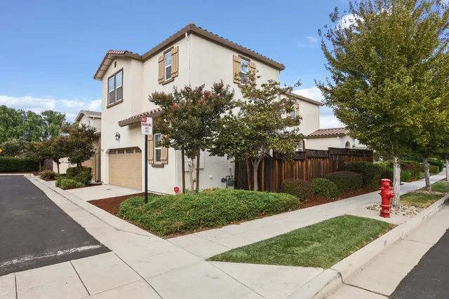 a view of a white house with a yard