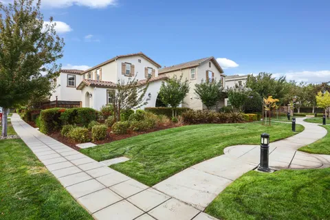 a view of a garden with a house in the background