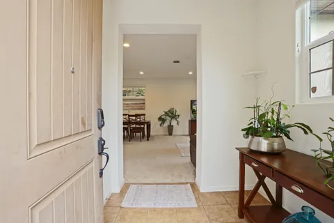 a hallway with table and chairs