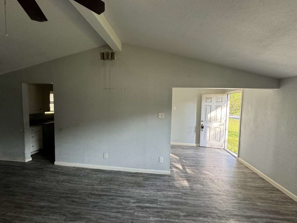 1301 Truman Street Cleveland, TX 77327 - Photo 3 of 11 a view of an empty room with wooden floor and a window
