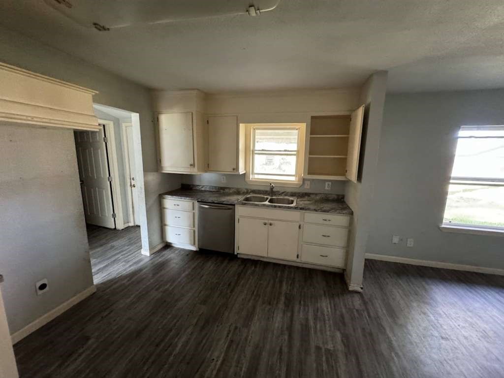 1301 Truman Street Cleveland, TX 77327 - Photo 5 of 11 a kitchen with stainless steel appliances a white counter top a sink and a window