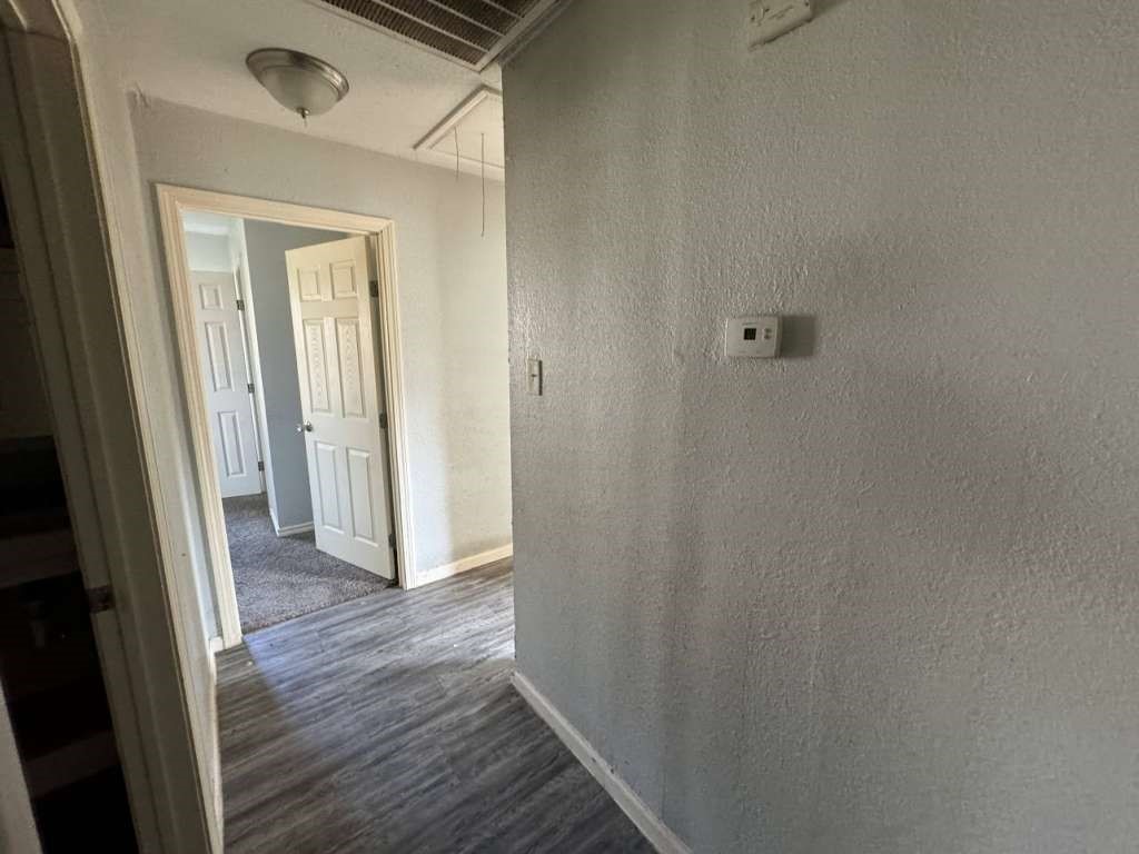 1301 Truman Street Cleveland, TX 77327 - Photo 7 of 11 a view of a hallway with wooden floor