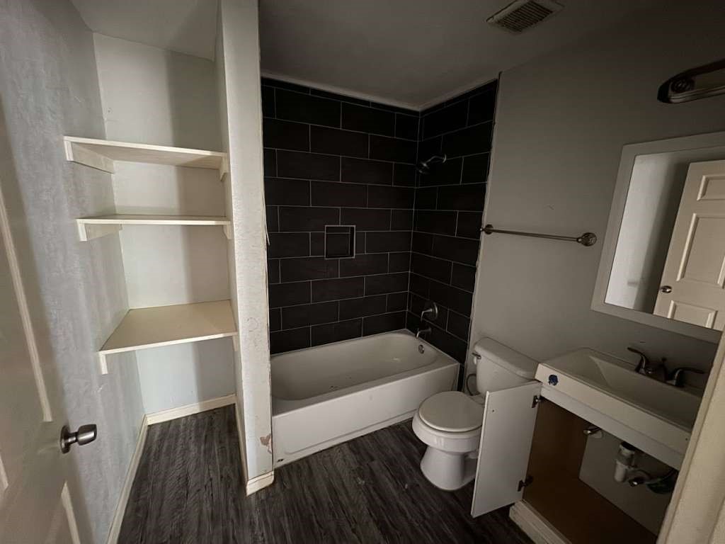 1301 Truman Street Cleveland, TX 77327 - Photo 10 of 11 a bathroom with a toilet and a shower