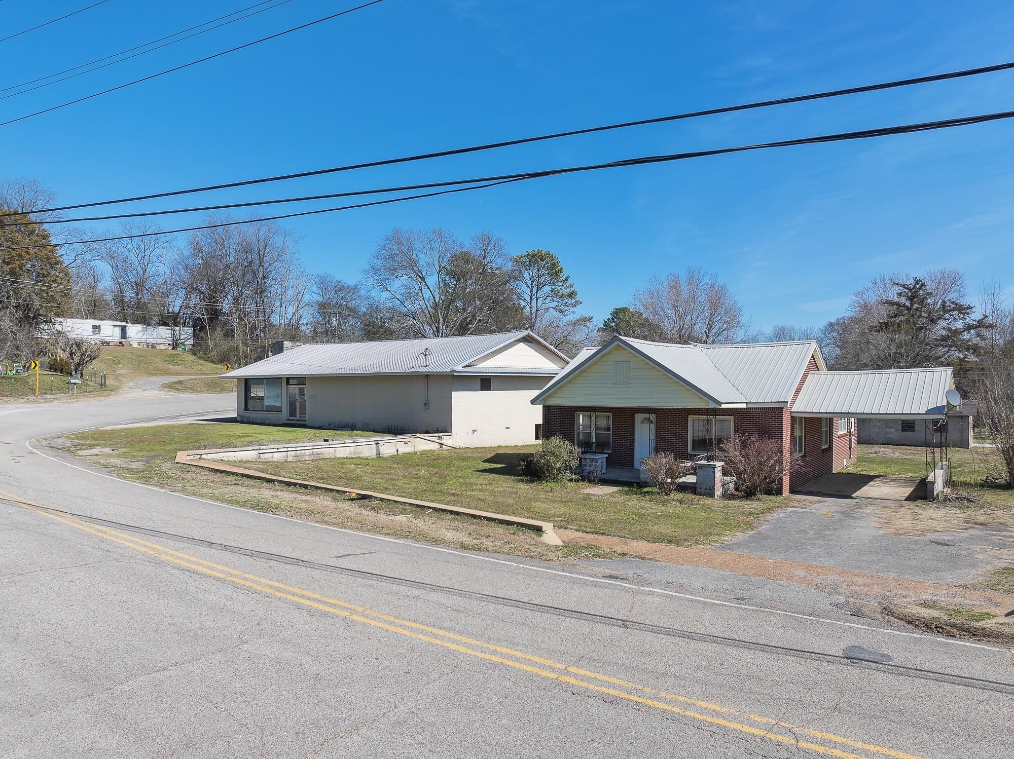 1175-1213 Perryville Road Parsons, TN 38363 - Photo 31 of 32 a view of a house with a big yard