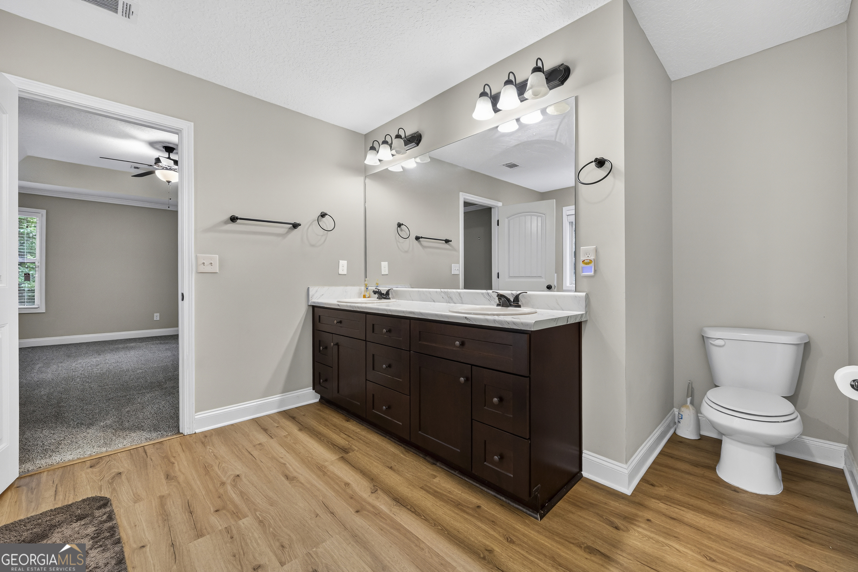 717 Oconee Lane Commerce, GA 30529 - Photo 21 of 57 a bathroom with a sink vanity and a toilet