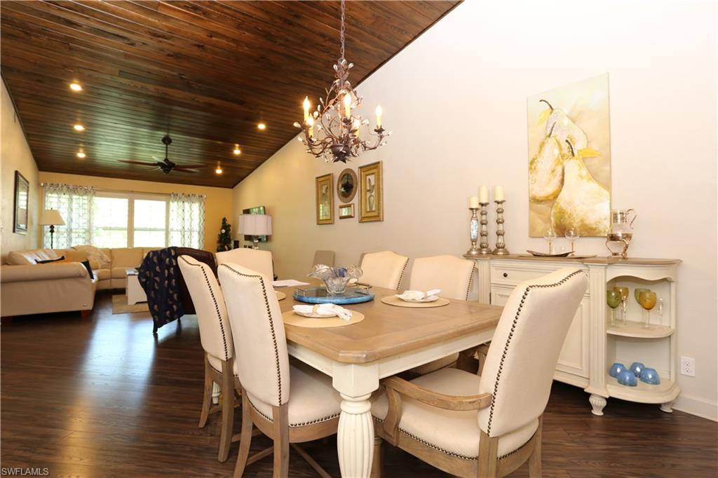 3563 Antarctic Circle, Unit 2102 Naples, FL 34112 - Photo 12 of 26 a view of a dining room with furniture and wooden floor
