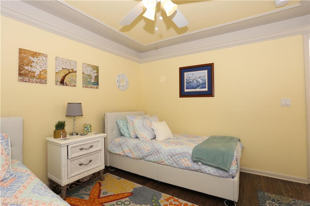 3563 Antarctic Circle, Unit 2102 Naples, FL 34112 - Photo 18 of 26 a bedroom with a bed and a window