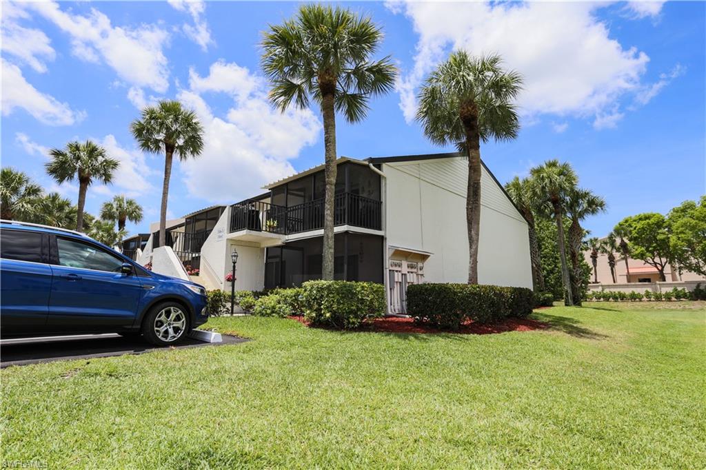 3563 Antarctic Circle, Unit 2102 Naples, FL 34112 - Photo 21 of 26 a front view of a house with garden