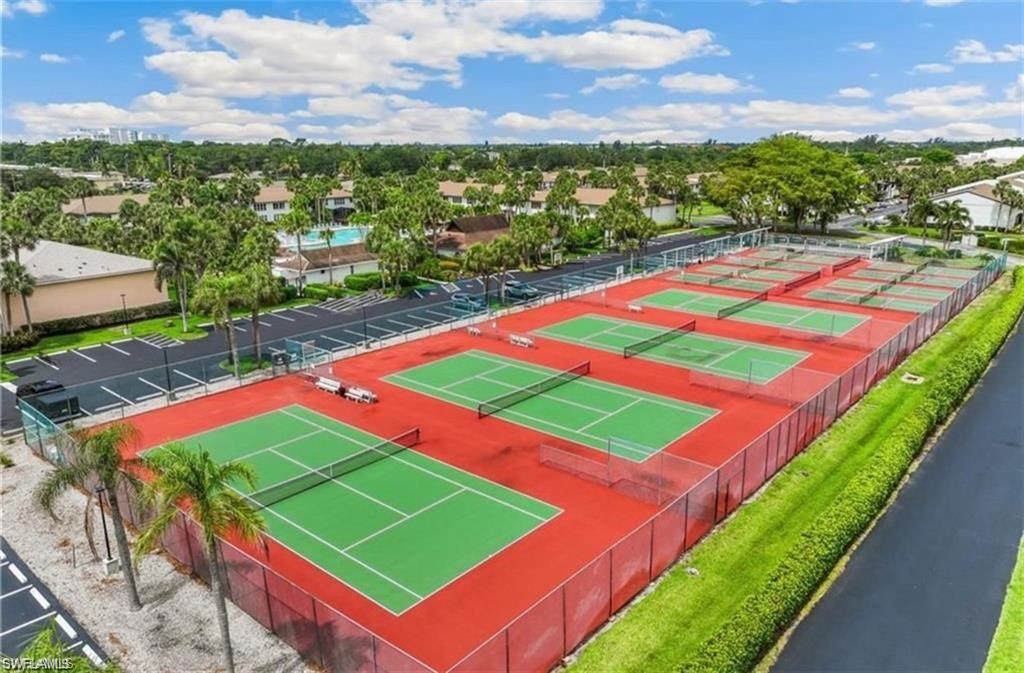 3563 Antarctic Circle, Unit 2102 Naples, FL 34112 - Photo 26 of 26 a view of a tennis ground with a big yard