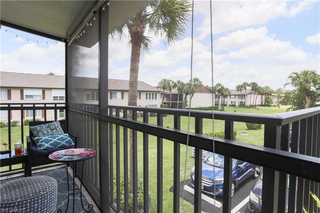 3563 Antarctic Circle, Unit 2102 Naples, FL 34112 - Photo 3 of 26 a view of a balcony with floor to ceiling windows with wooden floor