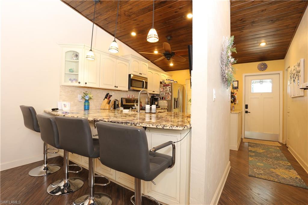 3563 Antarctic Circle, Unit 2102 Naples, FL 34112 - Photo 9 of 26 a kitchen with a table and chairs