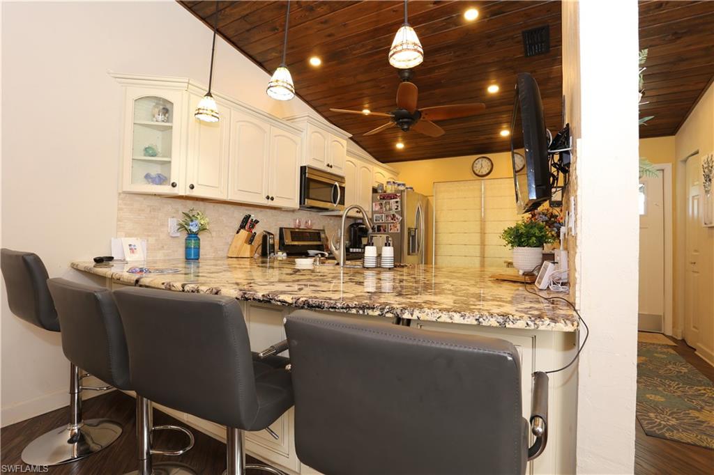 3563 Antarctic Circle, Unit 2102 Naples, FL 34112 - Photo 10 of 26 a kitchen with stainless steel appliances granite countertop a sink and cabinets