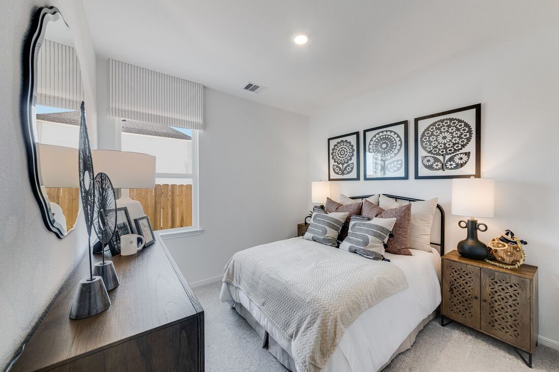 731 Willow Grove Lane Rosenberg, TX 77471 - Photo 14 of 23 a bedroom with a bed a mirror and furniture