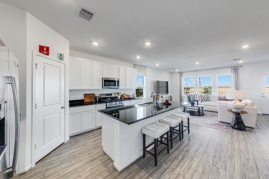 731 Willow Grove Lane Rosenberg, TX 77471 - Photo 5 of 23 a kitchen with sink cabinets and wooden floor