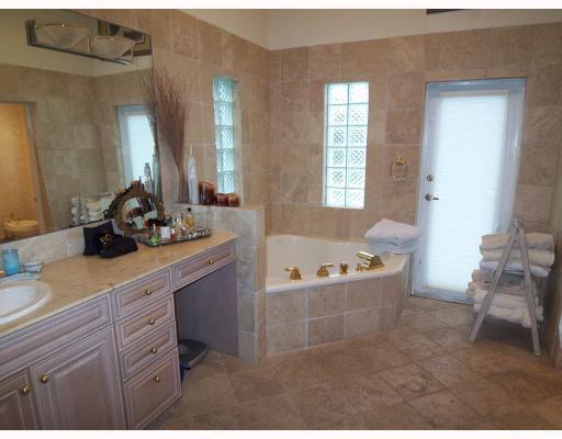 7149 Encina Lane Boca Raton, FL 33433 - Photo 17 of 22 a bathroom with a tub sink and mirror