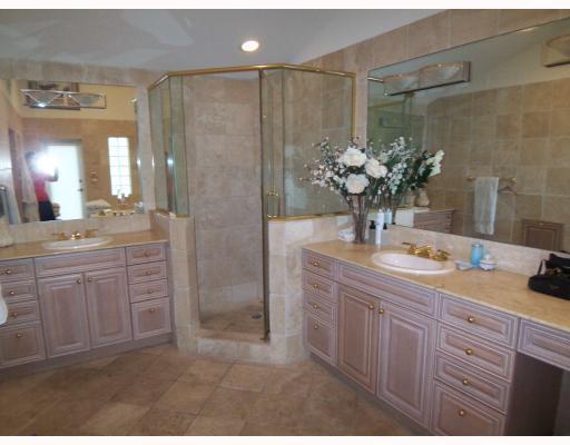 7149 Encina Lane Boca Raton, FL 33433 - Photo 18 of 22 a bathroom with a shower sink and mirror