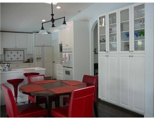 7149 Encina Lane Boca Raton, FL 33433 - Photo 4 of 22 a dining room with a table chairs and kitchen view