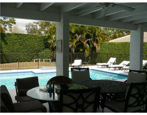 7149 Encina Lane Boca Raton, FL 33433 - Photo 7 of 22 a view of a living room and floor to ceiling window and an umbrella