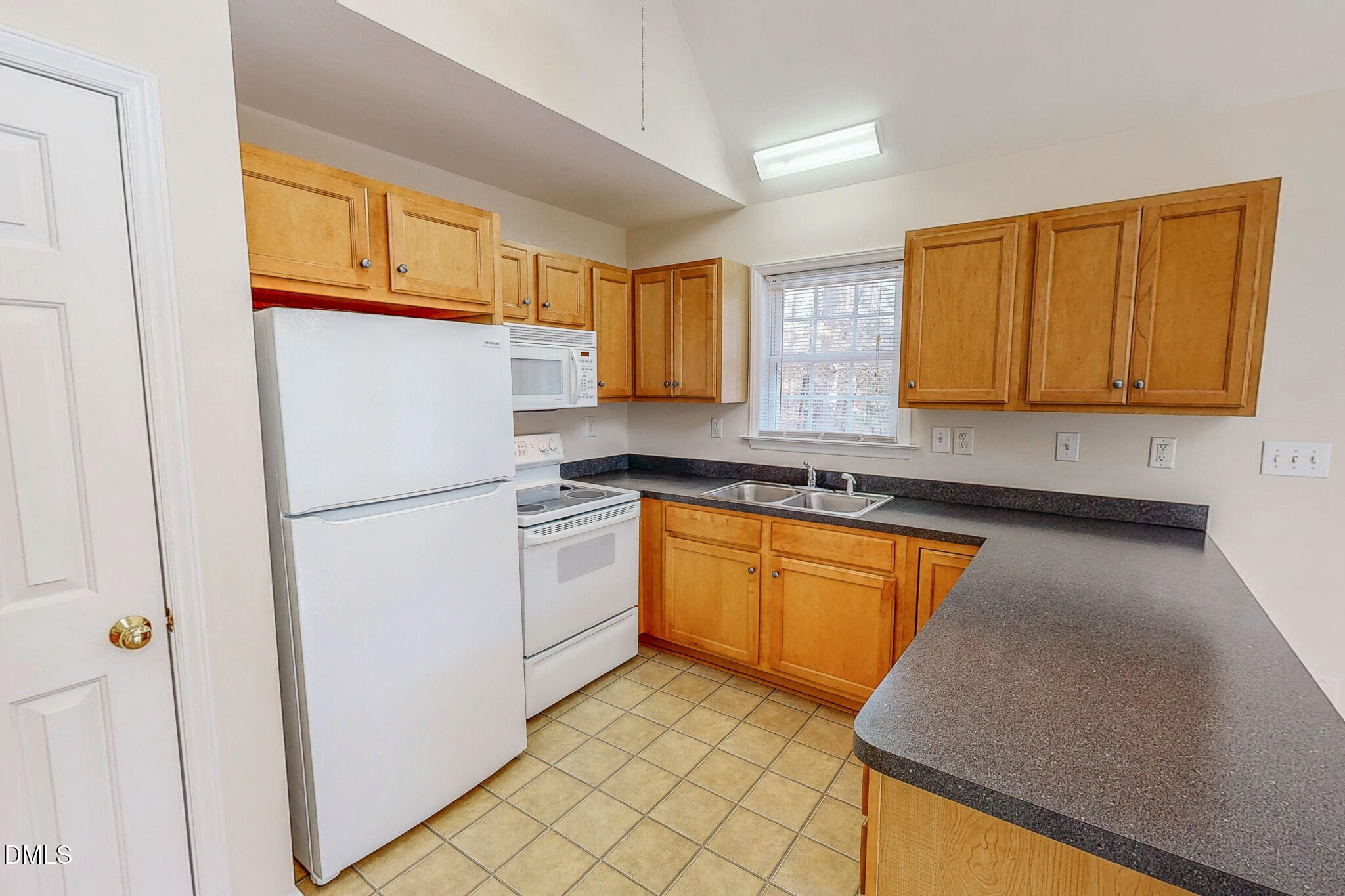 689 Lockamy Road Timberlake, NC 27583 - Photo 12 of 33 a kitchen with granite countertop cabinets and refrigerator