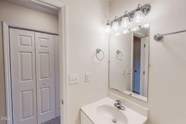 a bathroom with a sink and mirror