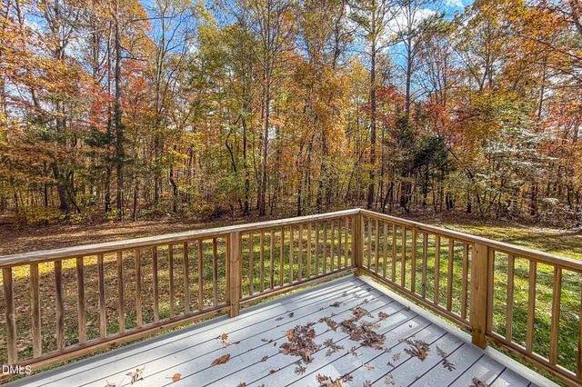 a view of balcony with wooden floor and fence