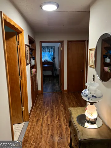 a living room with wooden floor and furniture