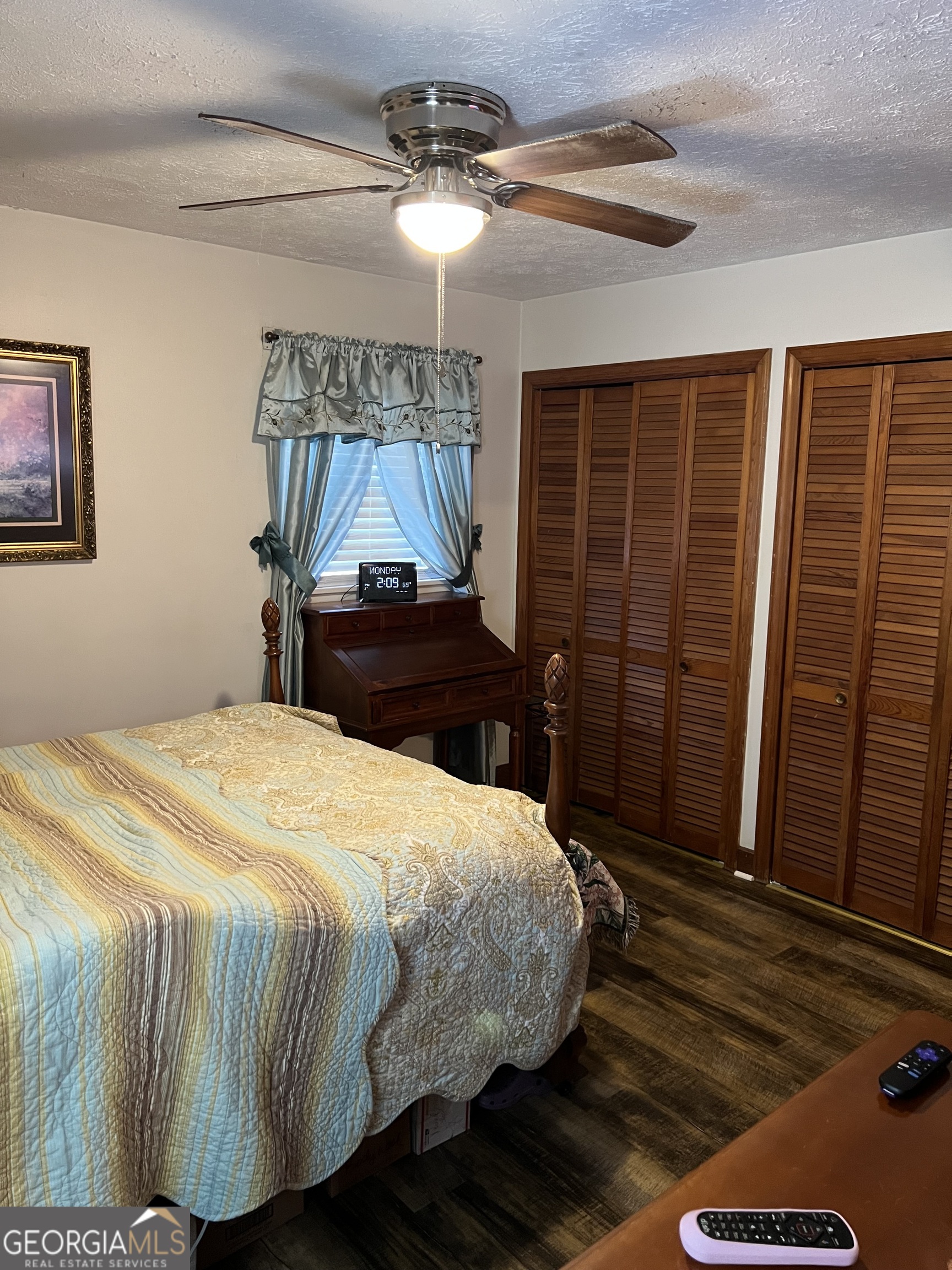 6419 Cochran Highway Cochran, GA 31014 - Photo 13 of 55 a bedroom with a bed and a chandelier