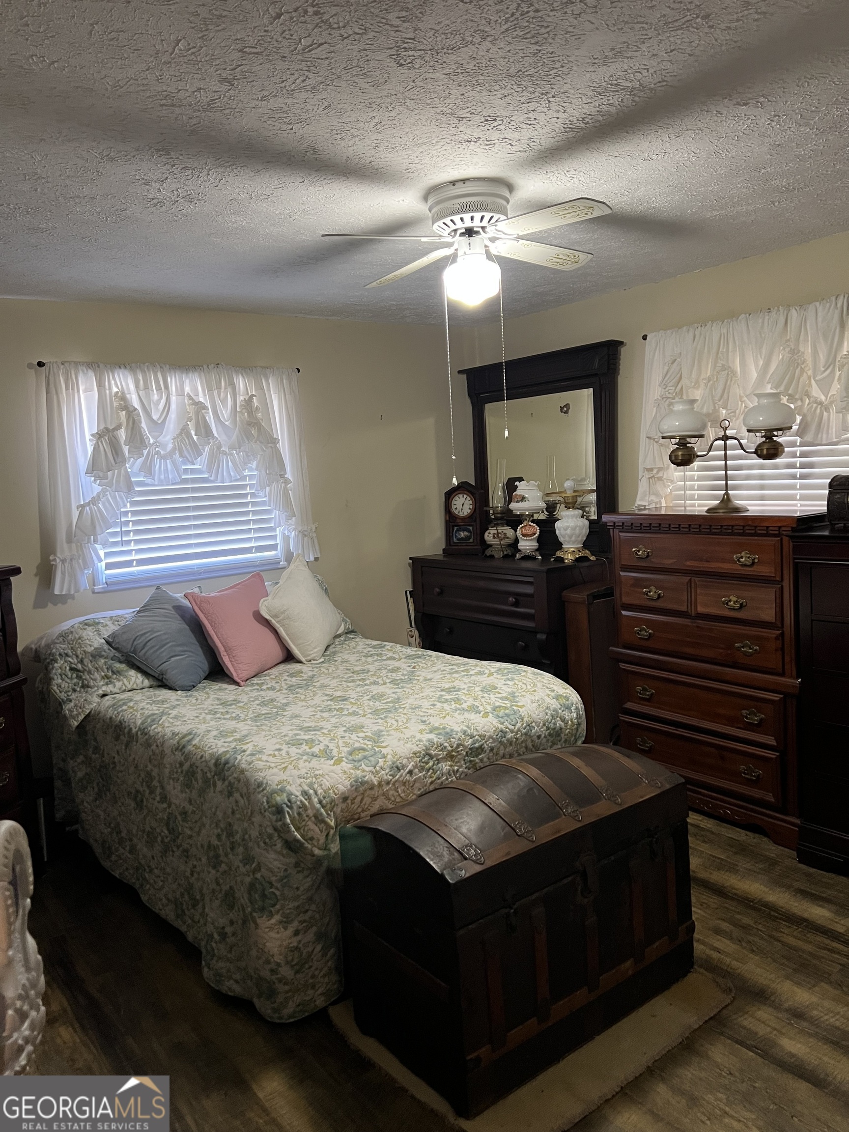 6419 Cochran Highway Cochran, GA 31014 - Photo 15 of 55 a bedroom with a bed and dresser with mirror