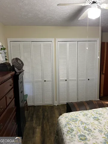 a bathroom with a toilet and a shower curtain
