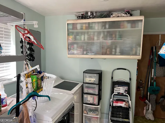 a view of a yard with plants and trees