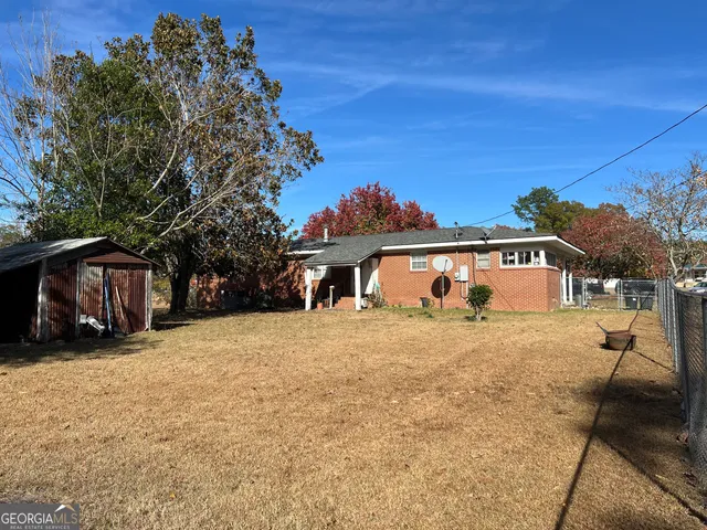 a backyard of a house with lots of green space