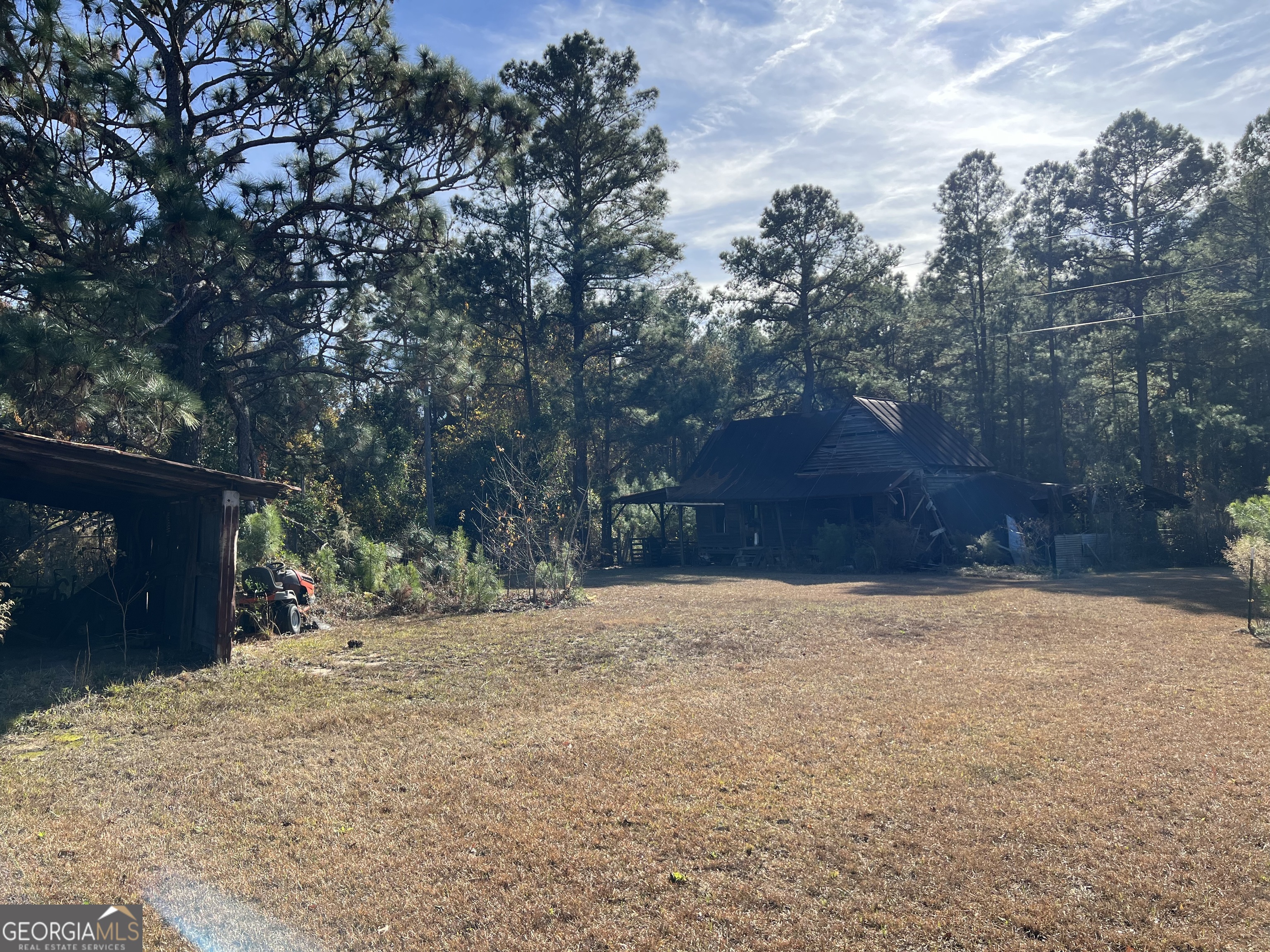 6419 Cochran Highway Cochran, GA 31014 - Photo 28 of 55 a backyard of a house with trees and stairs