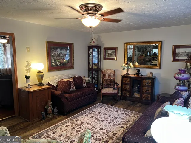 a living room with furniture two window and a table