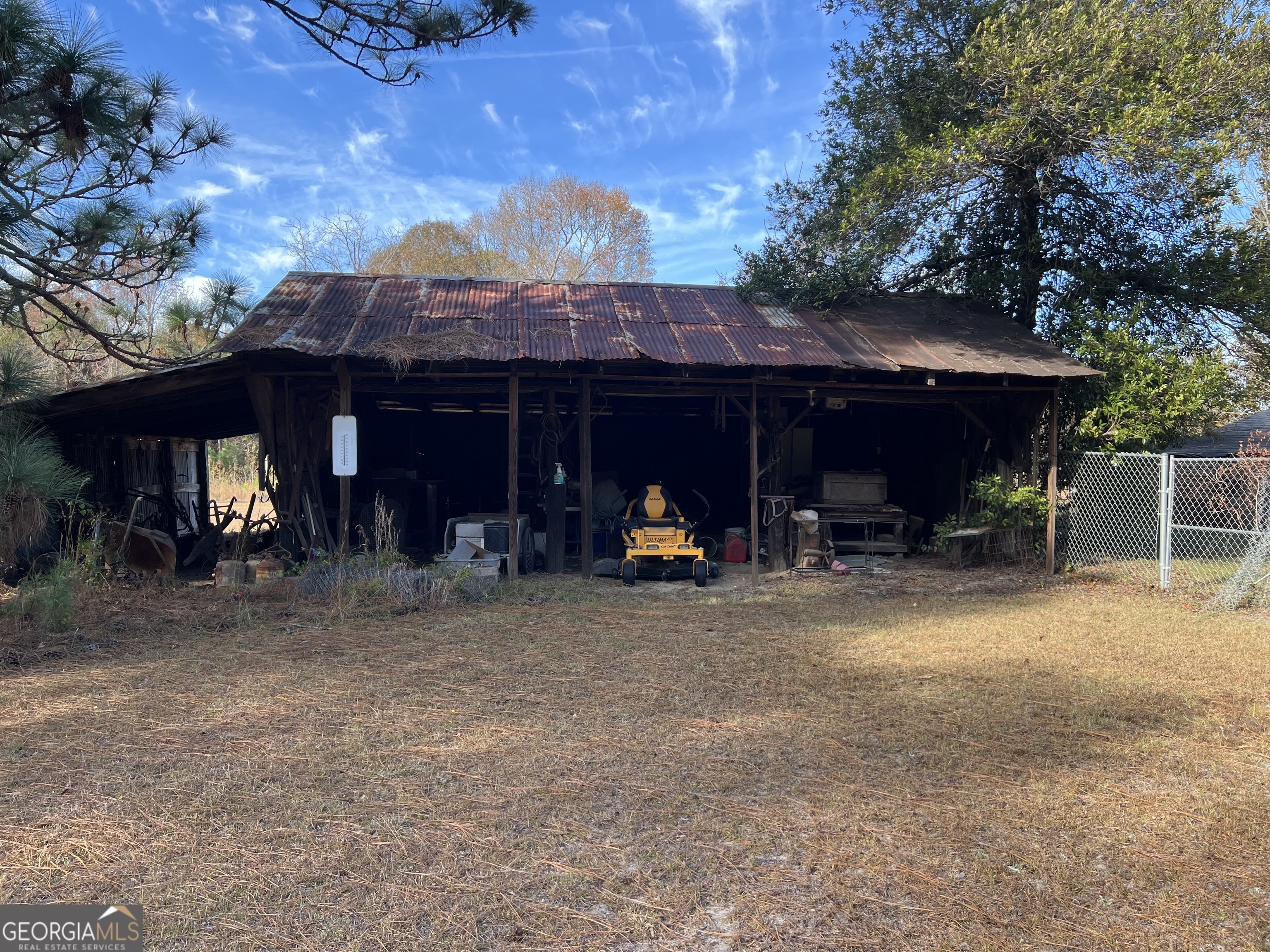 6419 Cochran Highway Cochran, GA 31014 - Photo 41 of 55 a view of a house with a patio and a yard