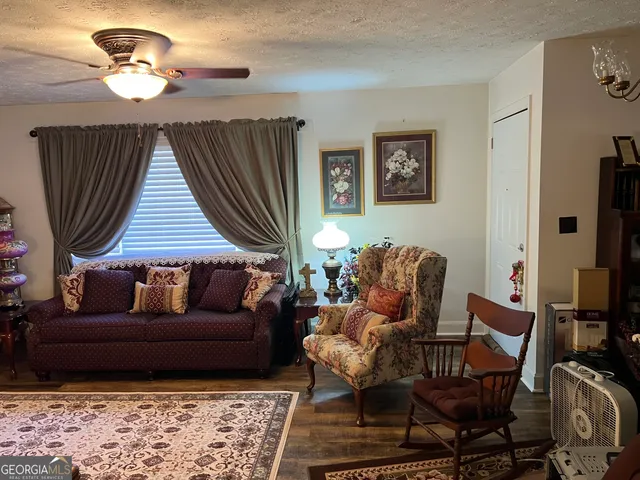 a living room with furniture a fireplace and a window